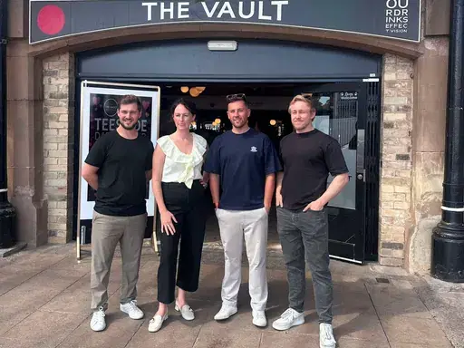 Four attendees posing outside The Vault ahead of a Darlington First coffee morning.